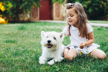 Child playing with dog