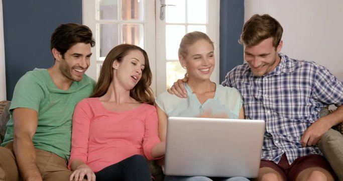 Happy couples using laptop together