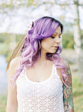 Sweden, Bride with long purple hair and tattoo at hippie wedding