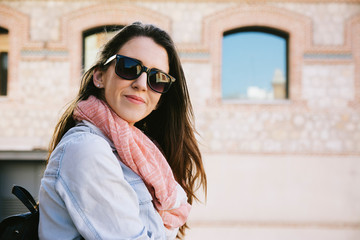 Urban portrait of woman wearing sunglasses in the