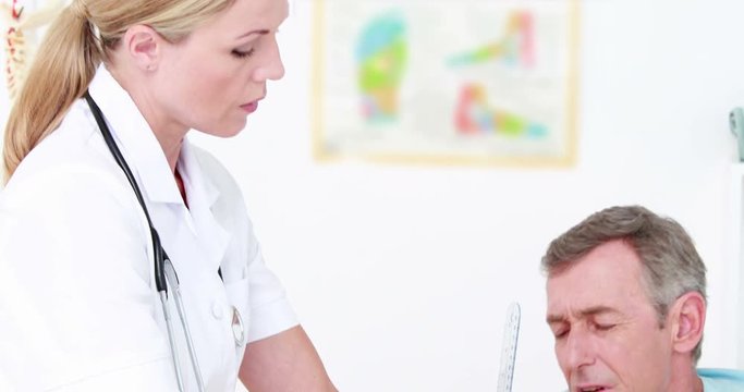 Doctor examining man hand with tools