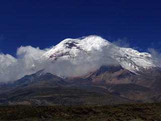 Ecuador&acute;s highest peak, glacieted Mt. Chimborazo, with clear blue sky and clouds