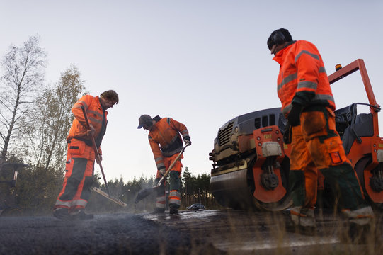 Sweden, Narke, Three manual workers repairing road