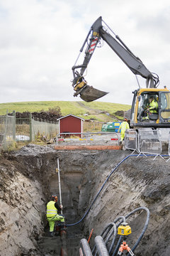 Sweden, Vastmanland, Three construction workers at construction site