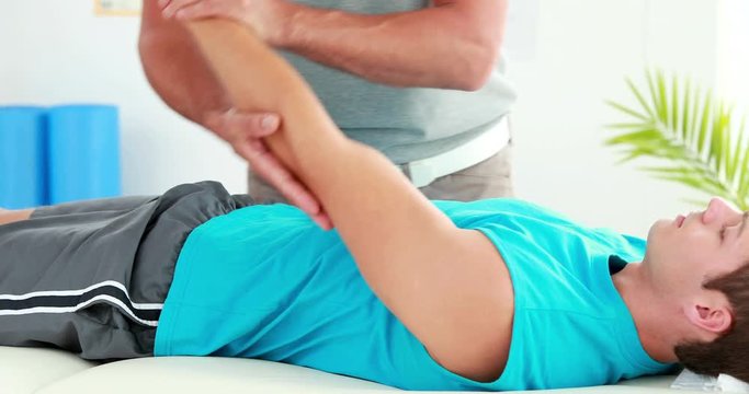 Physiotherapist giving sports massage to patient