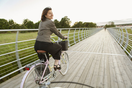 Sweden, Blekinge, Solvesborg, Mature woman riding on bicycle