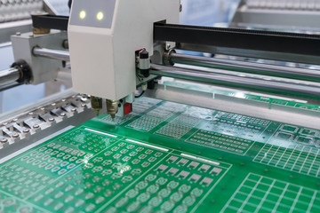 PCB Processing on CNC machine working in factory - obrazy, fototapety, plakaty