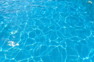 Fototapeta na wymiar Blue water surface in swimming pool