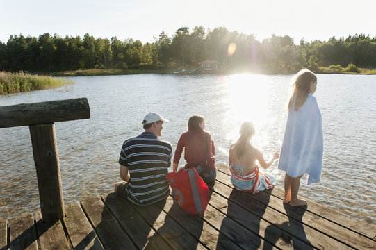 Sweden, Vastra Gotaland, Kallandso, Family with two children (6-7, 12-13) on pier
