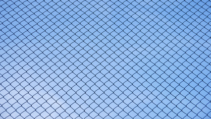 Green seamless fence chain, Iron wire fence on blue sky background