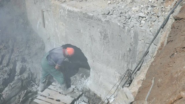 Worker repairing a manifold using disc saw grinder