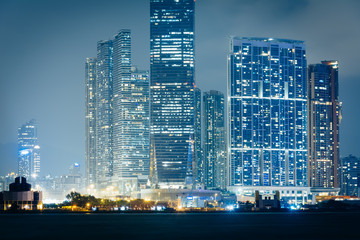 Naklejka premium The Kowloon skyline at night, seen from Sheung Wan, in Hong Kong