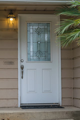 house entrance  door with weathered glass mosaic in art deco style