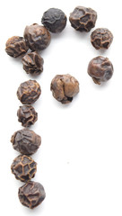 Black peppercorns organized as the letter P, isolated