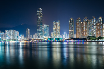 Fototapeta na wymiar The skyline of Tsuen Wan at night, seen from Tsing Yi, Hong Kong