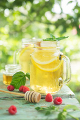Iced tea with lemon and raspberry.