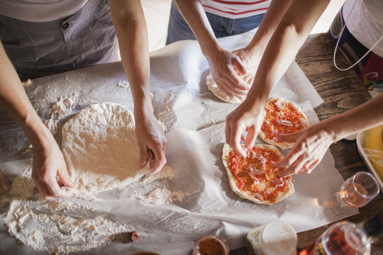 Italy, Tuscany, Women preparing homemade pizzas