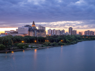 Saskatoon skyline at night along the Saskatchewan River.