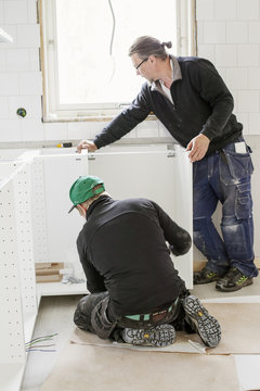 Sweden, Carpenters installing furniture