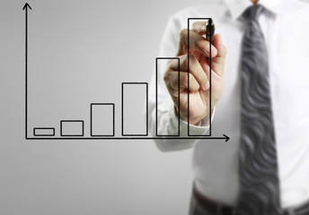 Businessman drawing graphics  growing graph