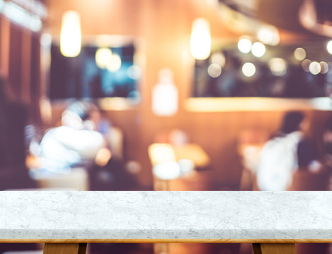 Empty white marble table top with blur coffee shop bokeh light a