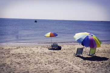 Beach umbrellas and chairs on a beach in Eastham, MA Cape Cod.
