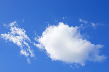 Big white puffy cumulus cloud on blue sky