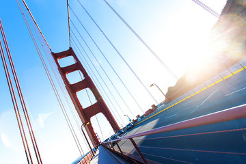 traffic on gold gate bridge with sunbeam