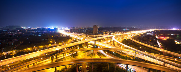 Fototapeta na wymiar busy traffic on road junction in downtown of hangzhou at night