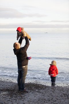 Father and daughter playing on beach