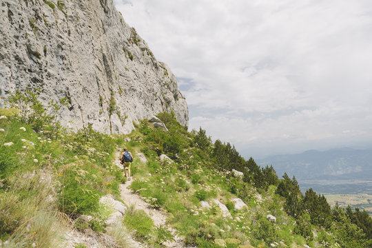 France, Pelleautier, Ceuse, Young man hiking along mountain footpath