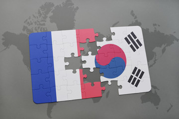 puzzle with the national flag of france and south korea on a world map background.