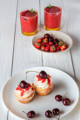 cupcakes with cherries and berry smoothies