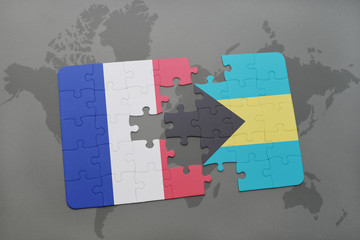 puzzle with the national flag of france and bahamas on a world map background.