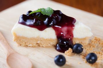 Close up blueberry cake on wooden plate on wood table.