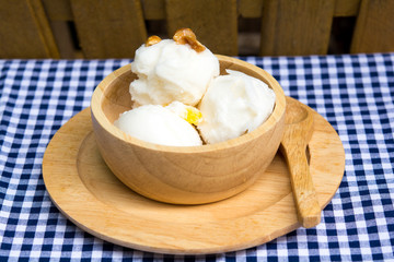 coconut ice cream in wood cup on table
