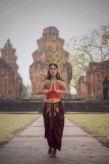 A beautiful woman in dancer apsara costume at stone castle,public place in Thailand
