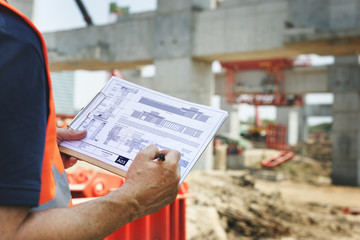 Construction Site Engineerer Working Blueprint
