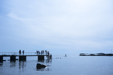Sweden, Skane, Torekov, Silhouettes of people standing on pier