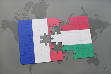 puzzle with the national flag of france and hungary on a world map background.