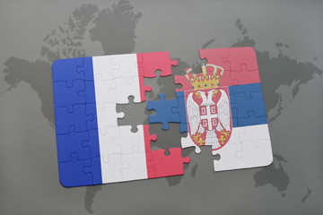 puzzle with the national flag of france and serbia on a world map background.