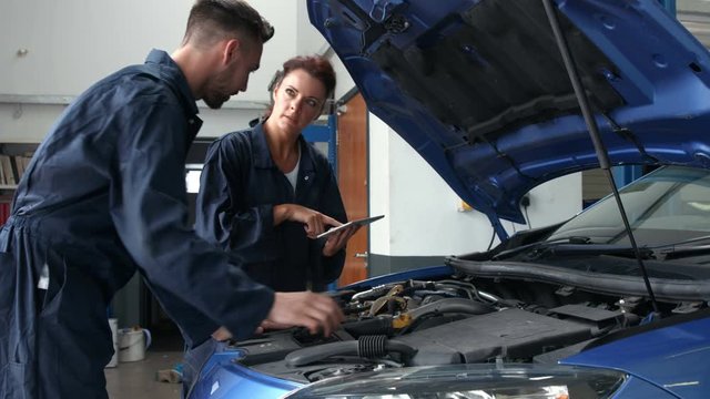 Mechanics overhauling an engine in the garage