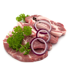 Raw pork neck chop meat with parsley herb leaves, peppercorn spi