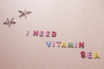 quote "I need vitamin sea" with starfishes on brown paper