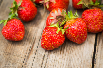 Ripe strawberries on the wooden table. Shallow depth fo field.