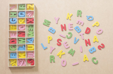 colorful alphabets on brown paper with alphabet box