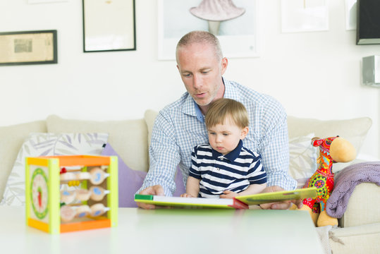 Sweden, Man reading to his son (18-23 months)