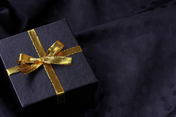 black gift box with golden ribbon