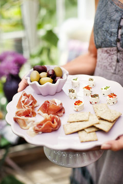 Sweden, Sodermanland, Woman holding plate with appetizers
