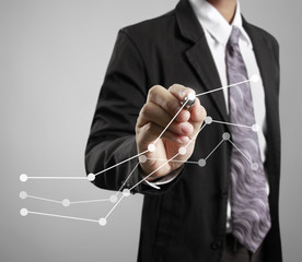 Businessman drawing graphics  growing graph